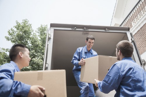 Professional movers preparing furniture for transport in Hoxton