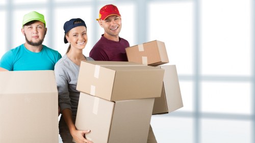 Professional movers carrying furniture in Hoxton