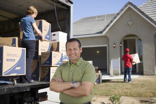 Professional movers transporting furniture for a Hoxton home relocation